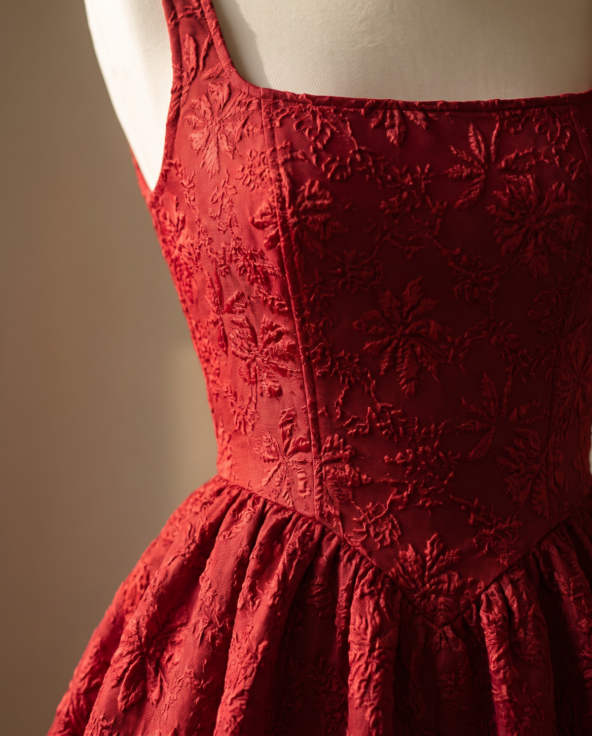 Detail of the BIA Aurelia Square-Neck Midi showing the raised floral jacquard and pointed waist seam.