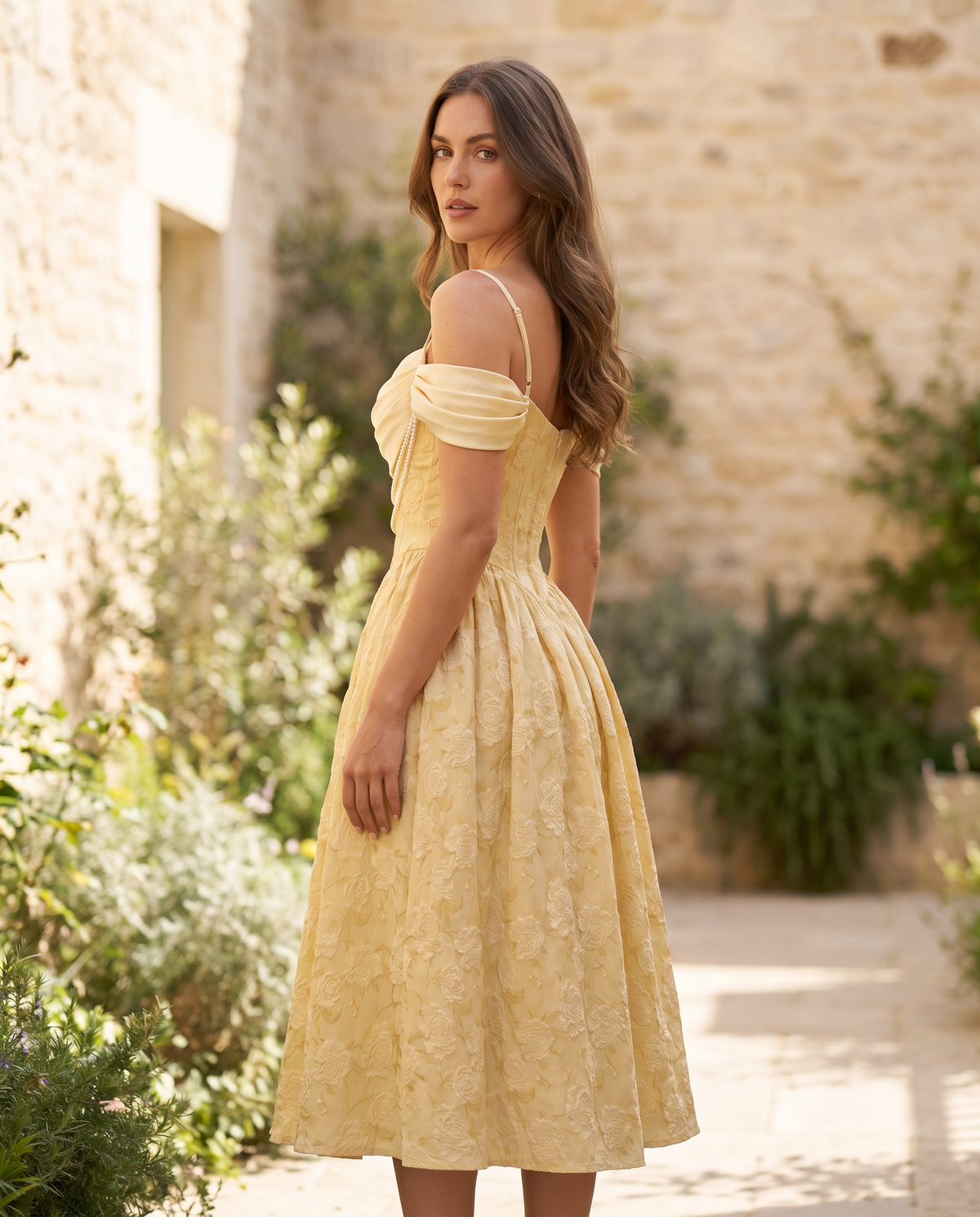 The BIA Séraphine Pearl Midi from a three-quarter angle in a sunlit courtyard.