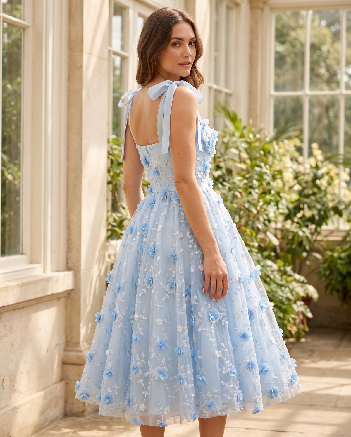 The BIA Celeste Appliqué Midi from a three-quarter angle, showing the bow straps and appliquéd tulle.