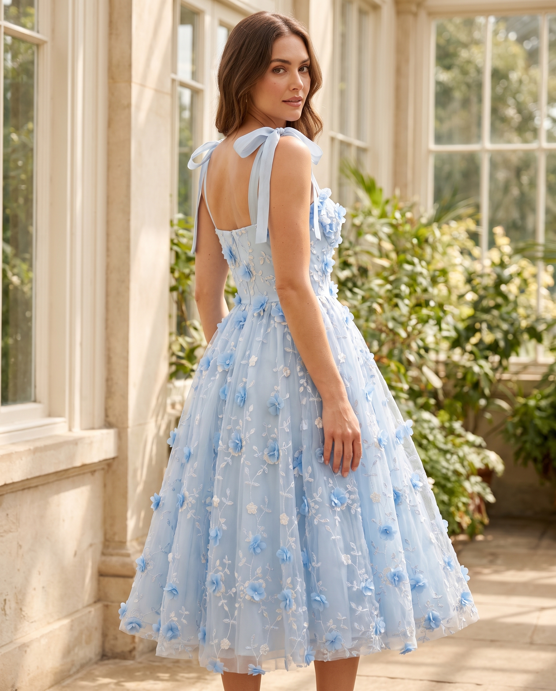 The BIA Celeste Appliqué Midi from a three-quarter angle, showing the bow straps and appliquéd tulle.