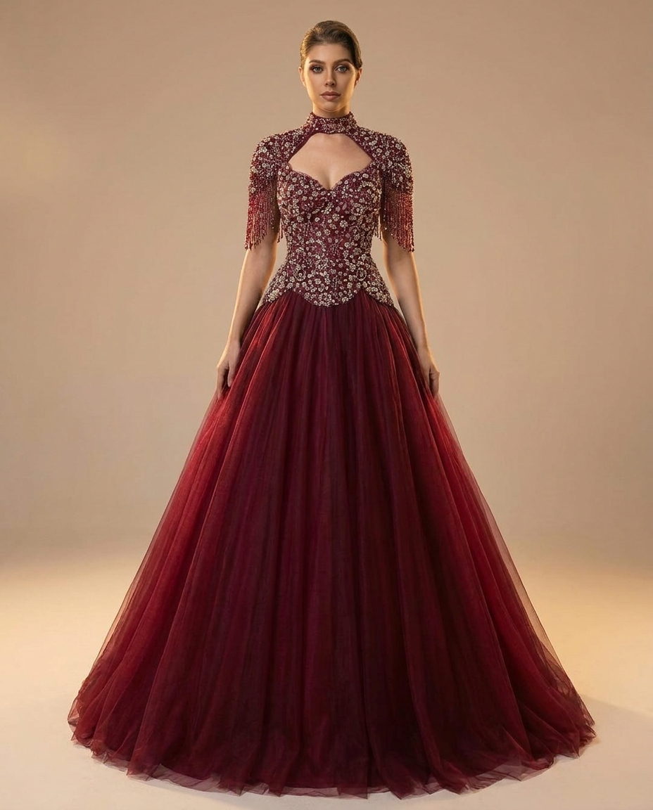 Adult model wearing the BIA Ophelia Embellished Gown in burgundy, with a beaded fringe capelet over a sweetheart bodice and a full tulle skirt, full-length front view.