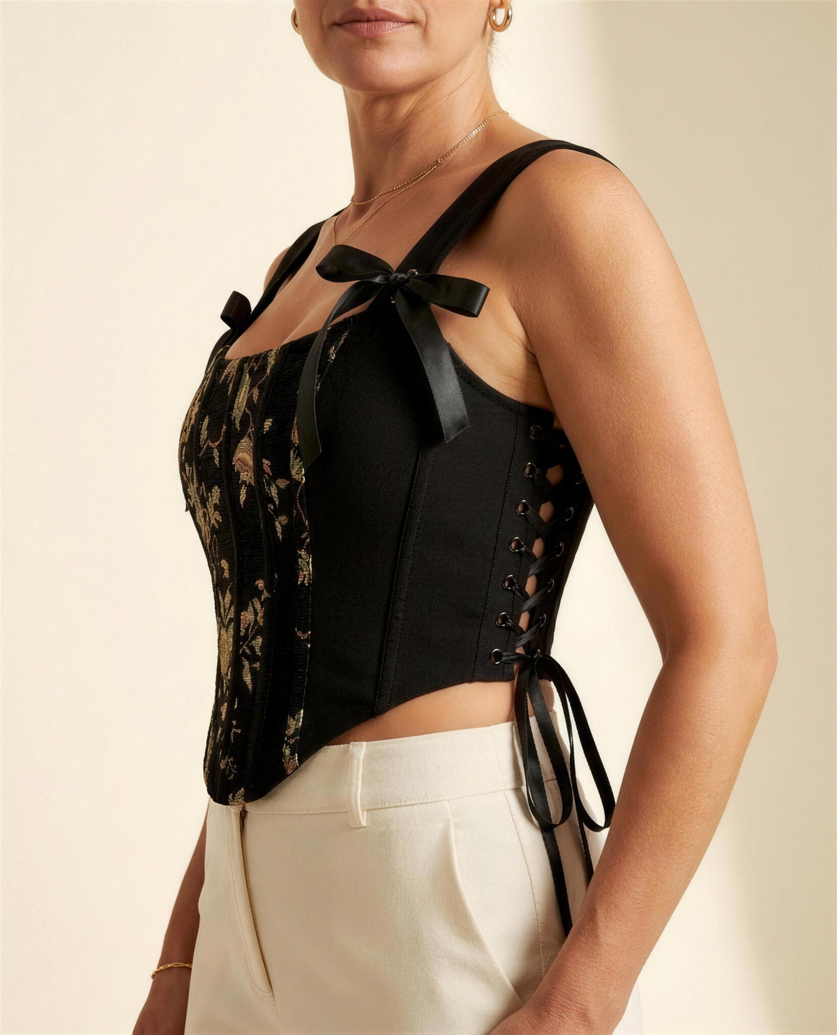 BIA black jacquard bustier, three-quarter view showing the side grommet lacing with hanging ties and the cropped curved hem.