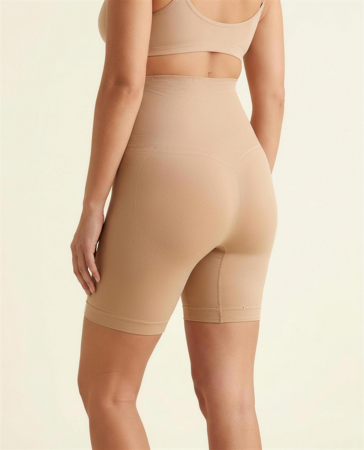 BIA warm beige seamless high-waist shaping short, three-quarter rear view showing full coverage and the shaping seam.