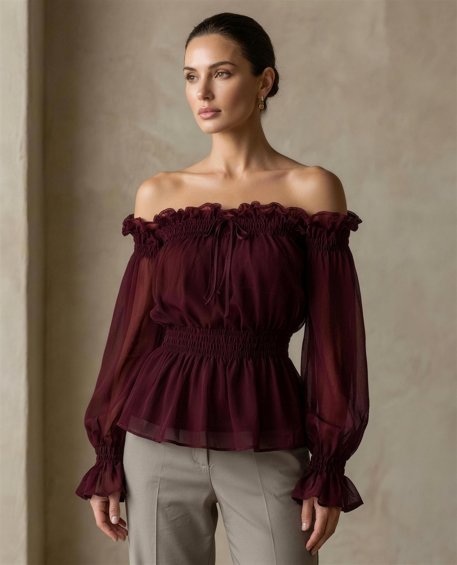 The Cassia Off-Shoulder Blouse in burgundy chiffon, shirred neckline with ruffle edge and bishop sleeves