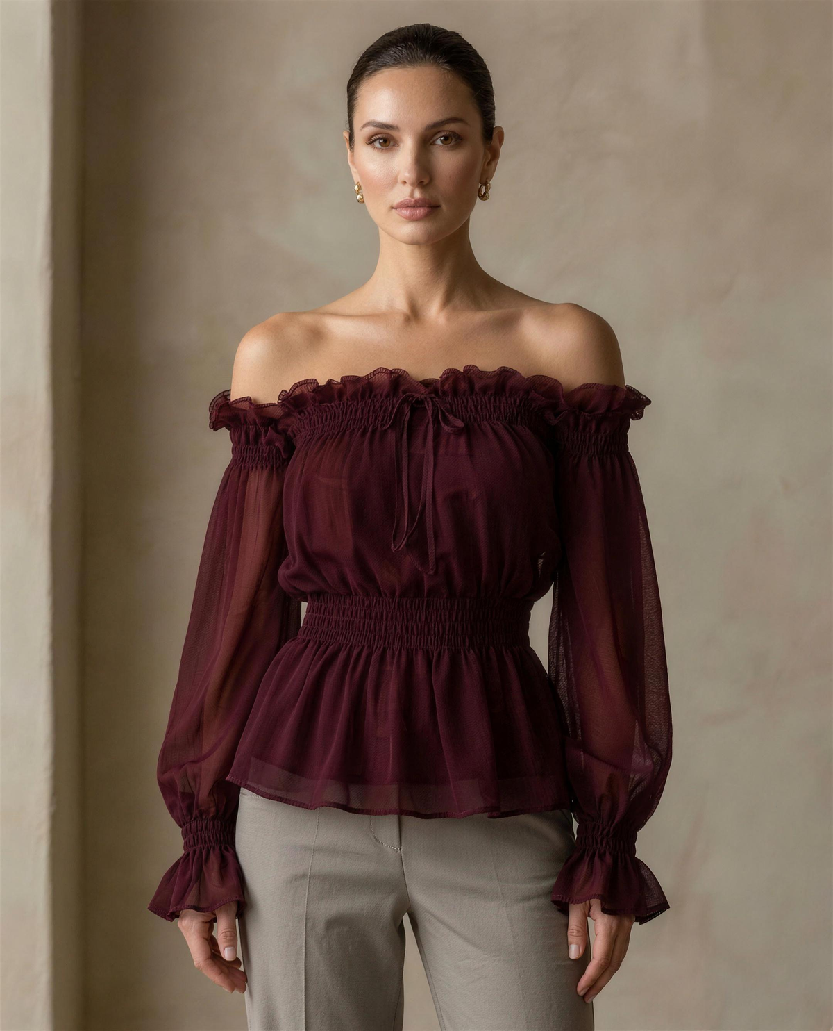 The Cassia Off-Shoulder Blouse in burgundy, full front view showing the shirred waist and flared hem