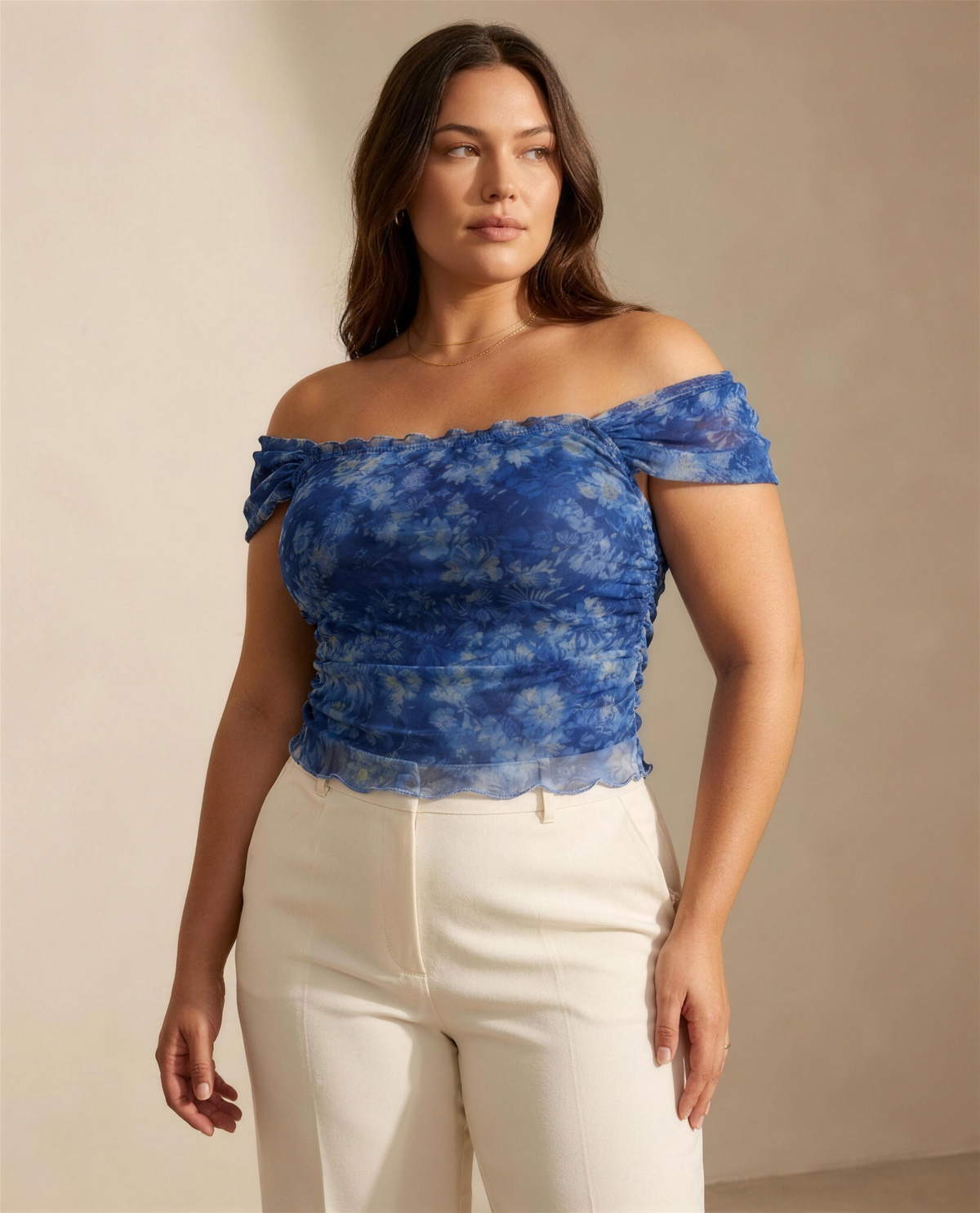 The Isolde Mesh Off-Shoulder Top in blue watercolour floral mesh with lettuce-edged neckline and cap sleeves