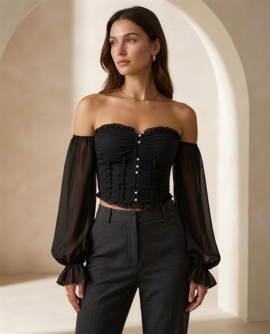 The Aveline Pearl-Button Blouse in black, three-quarter view