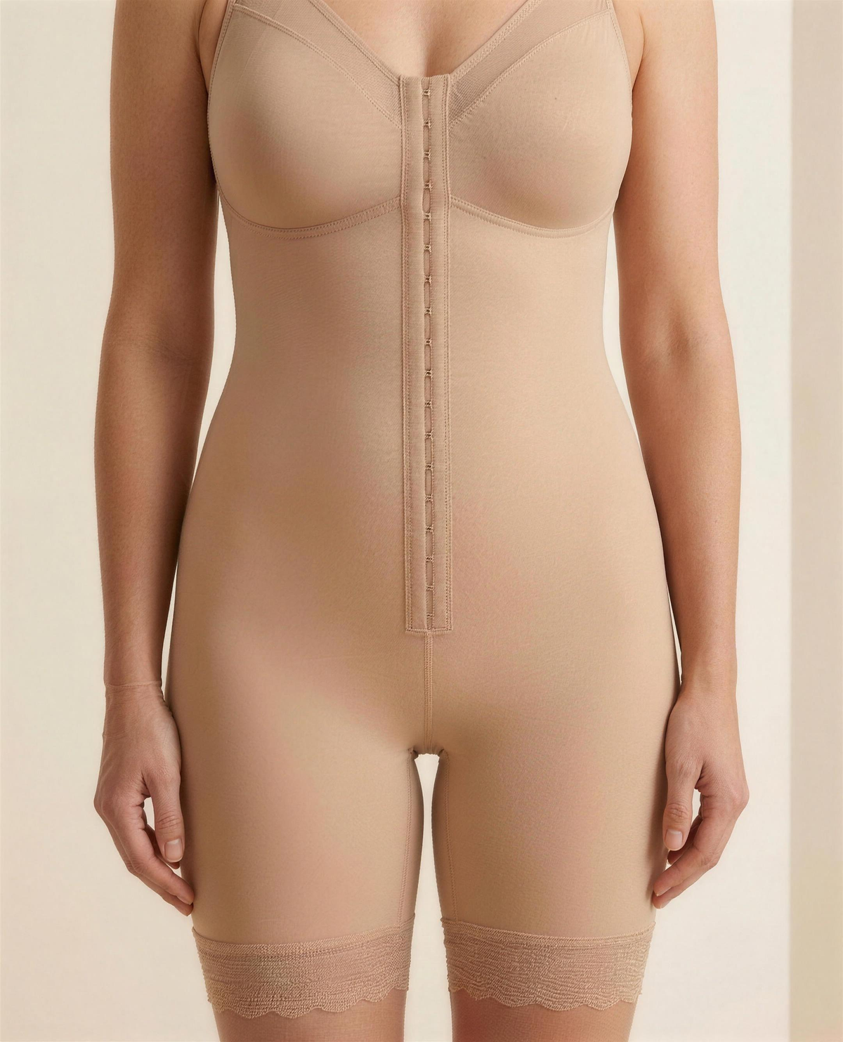 Close detail of the hook-and-eye front placket, mesh neckline panel and scalloped lace hem