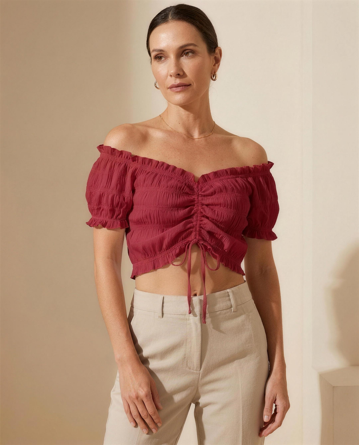 The Neve Ruched Crop Blouse in red, three-quarter view