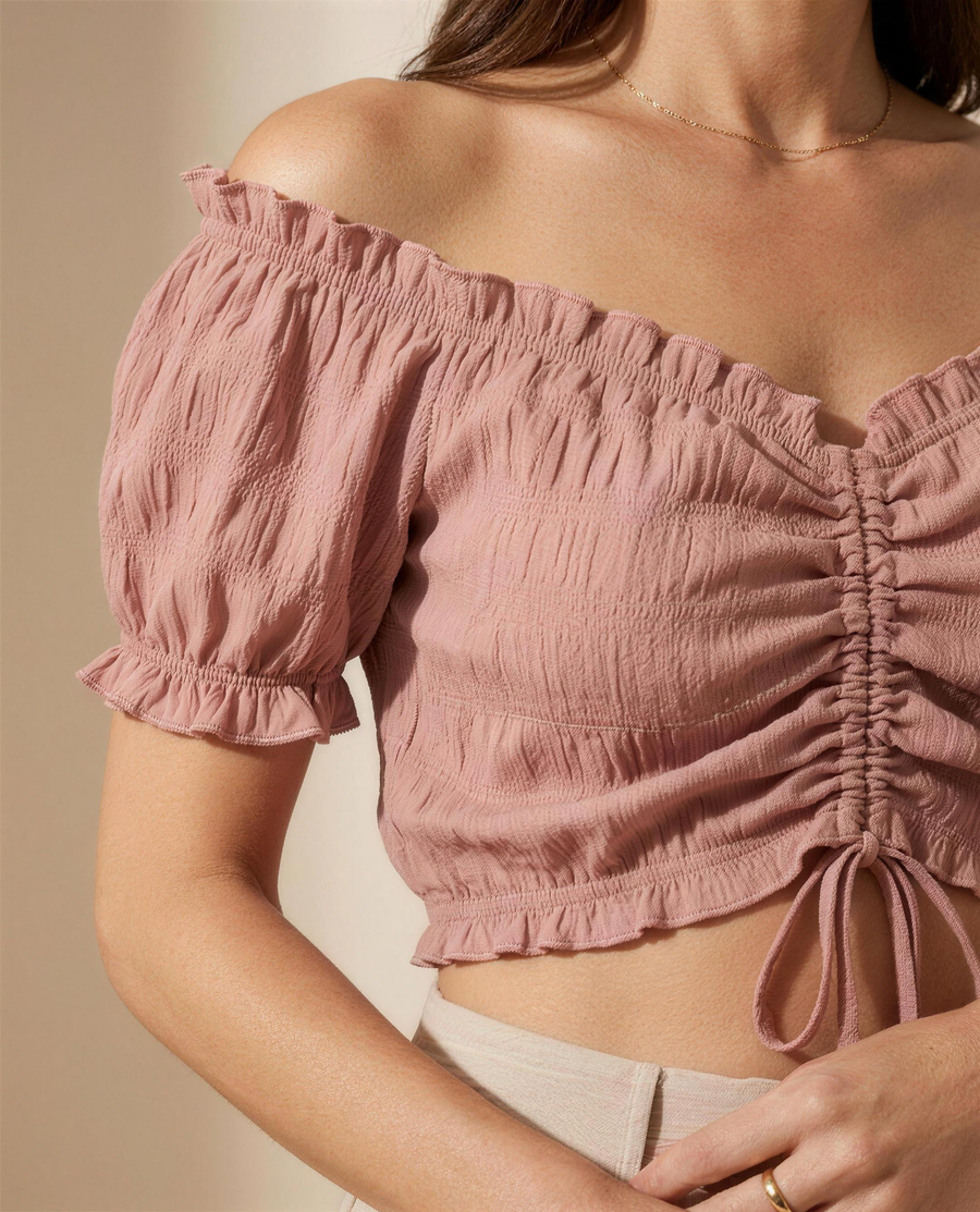 Close detail of the crinkled texture, frilled neckline and drawstring ruching on the Elowen Ruched Blouse