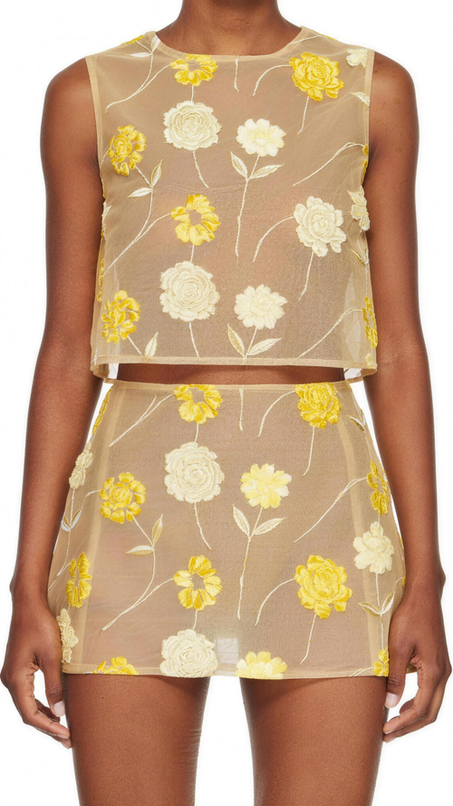 The Amalie Embroidered Floral Top — full front view, semi-sheer beige mesh with raised 3D yellow and ivory floral embroidery on green stems, high round crew neck, sleeveless, cropped at the waist